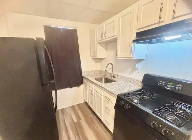 a kitchen with a sink stove and refrigerator