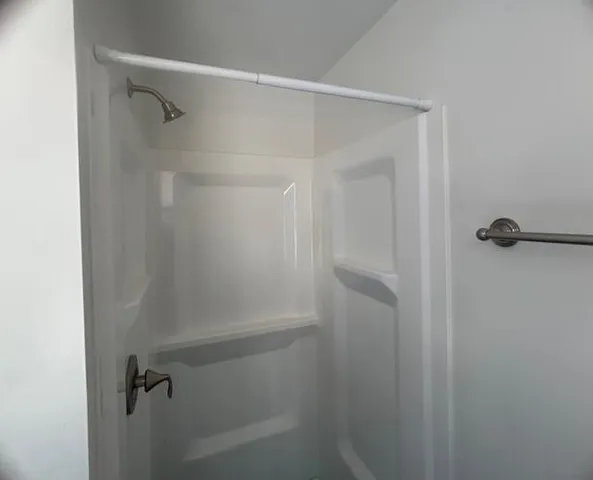 a bathroom with a glass shower door