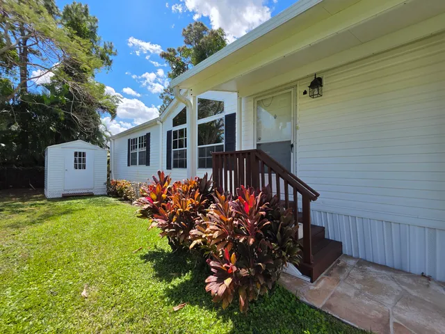 a view of a house with wooden fence