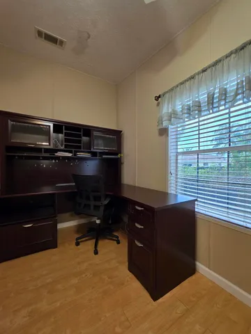 a room with table chair and wooden floor