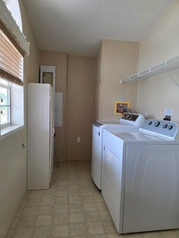 a utility room with cabinets washer and dryer