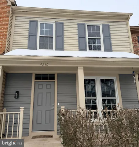 front view of a brick house with large windows