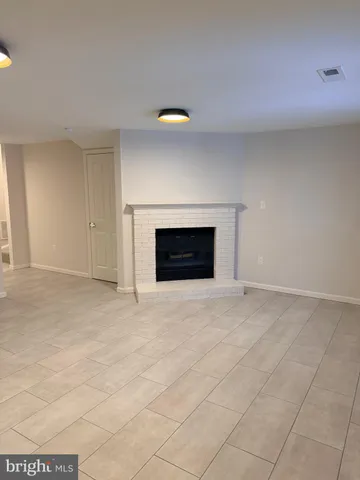 a view of empty room with fireplace