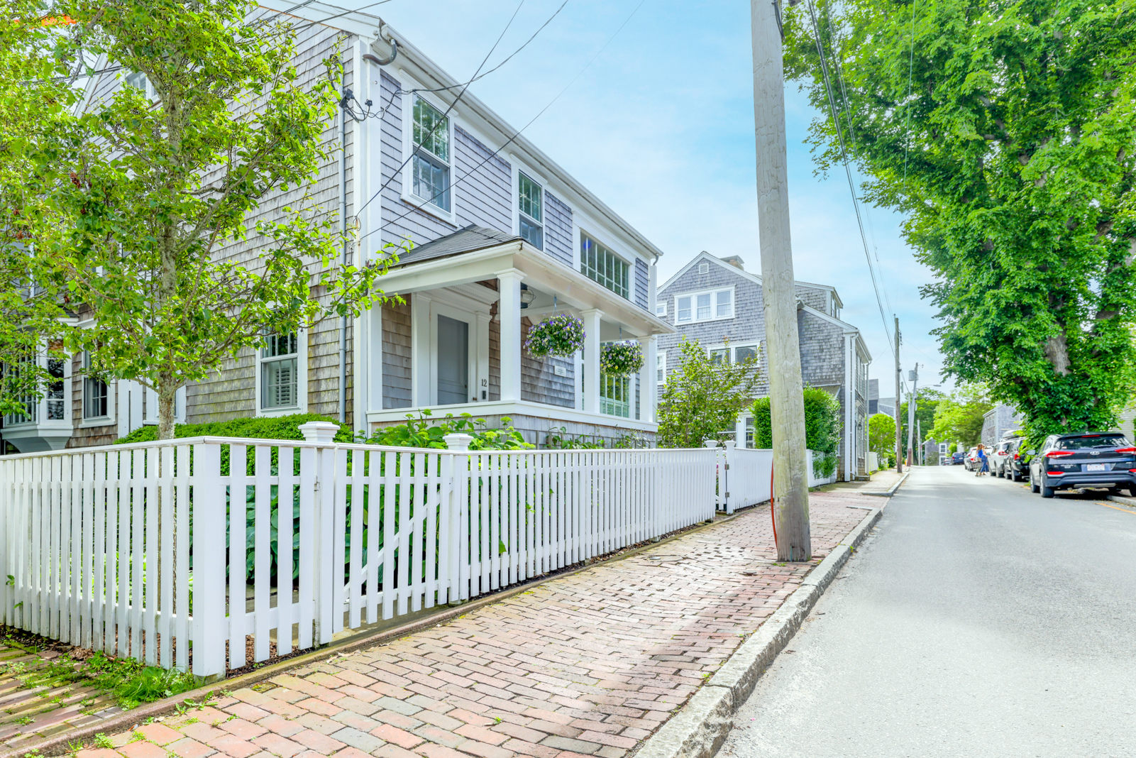 12 Hussey Street Nantucket, MA 02554 - Photo 45 of 47 a view of a brick house with large trees and plants