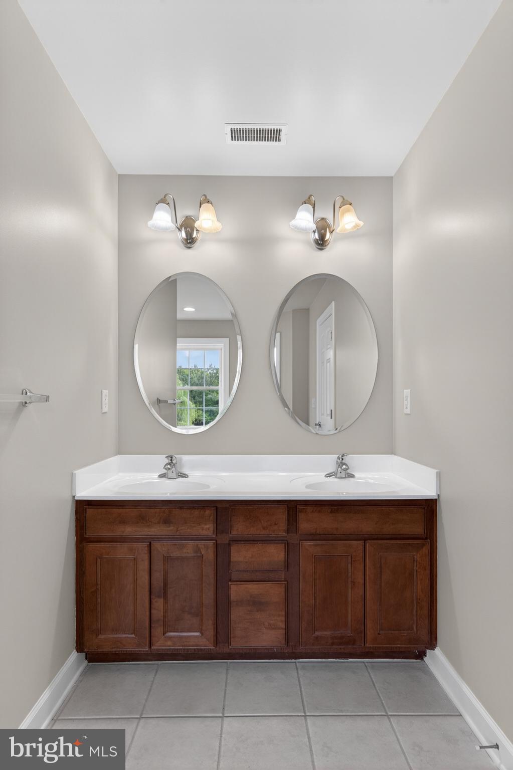 337 Roe Ingleside Road Centreville, MD 21617 - Photo 40 of 56 a bathroom with a double vanity sink and a mirror