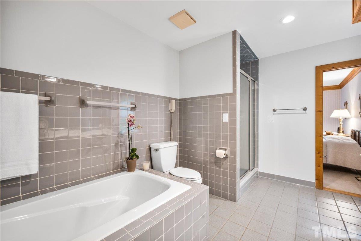 1625 Rougemont Road Rougemont, NC 27572 - Photo 19 of 30 a bathroom with a bathtub and a shower