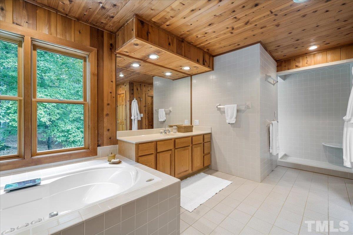 1625 Rougemont Road Rougemont, NC 27572 - Photo 26 of 30 a bathroom with a sink mirror and a bathtub