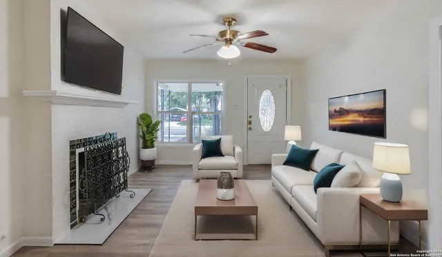 a living room with furniture a fireplace and a flat screen tv