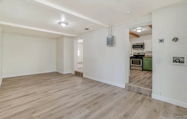 a view of a kitchen cabinets and wooden floor