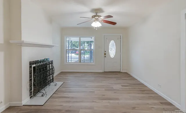 wooden floor in an empty room with a window