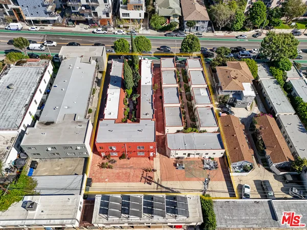 an aerial view of residential houses with outdoor space