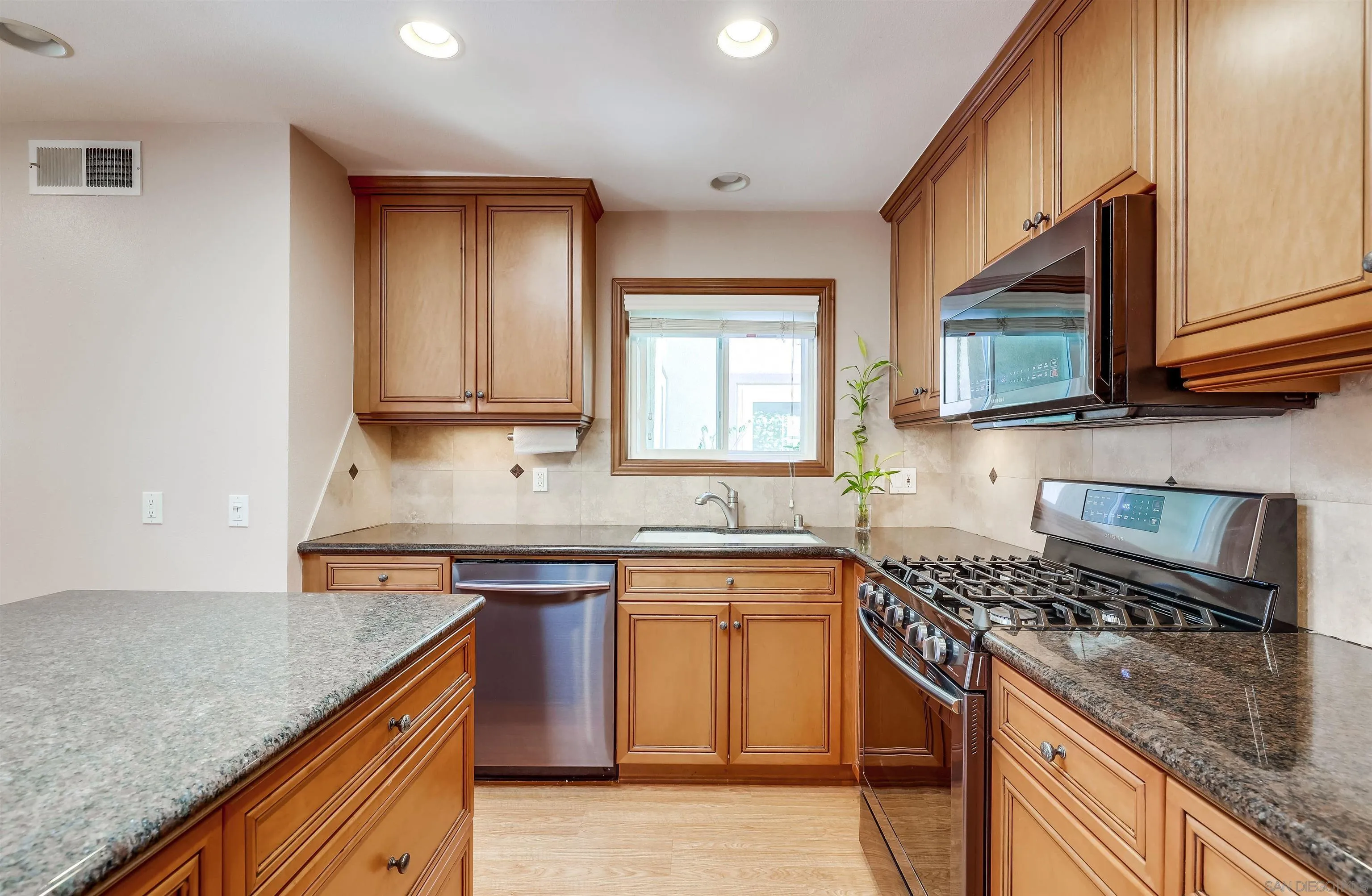 14039 Hermosillo Way Poway, CA 92064 - Photo 2 of 31 a kitchen with stainless steel appliances granite countertop a sink stove and cabinets