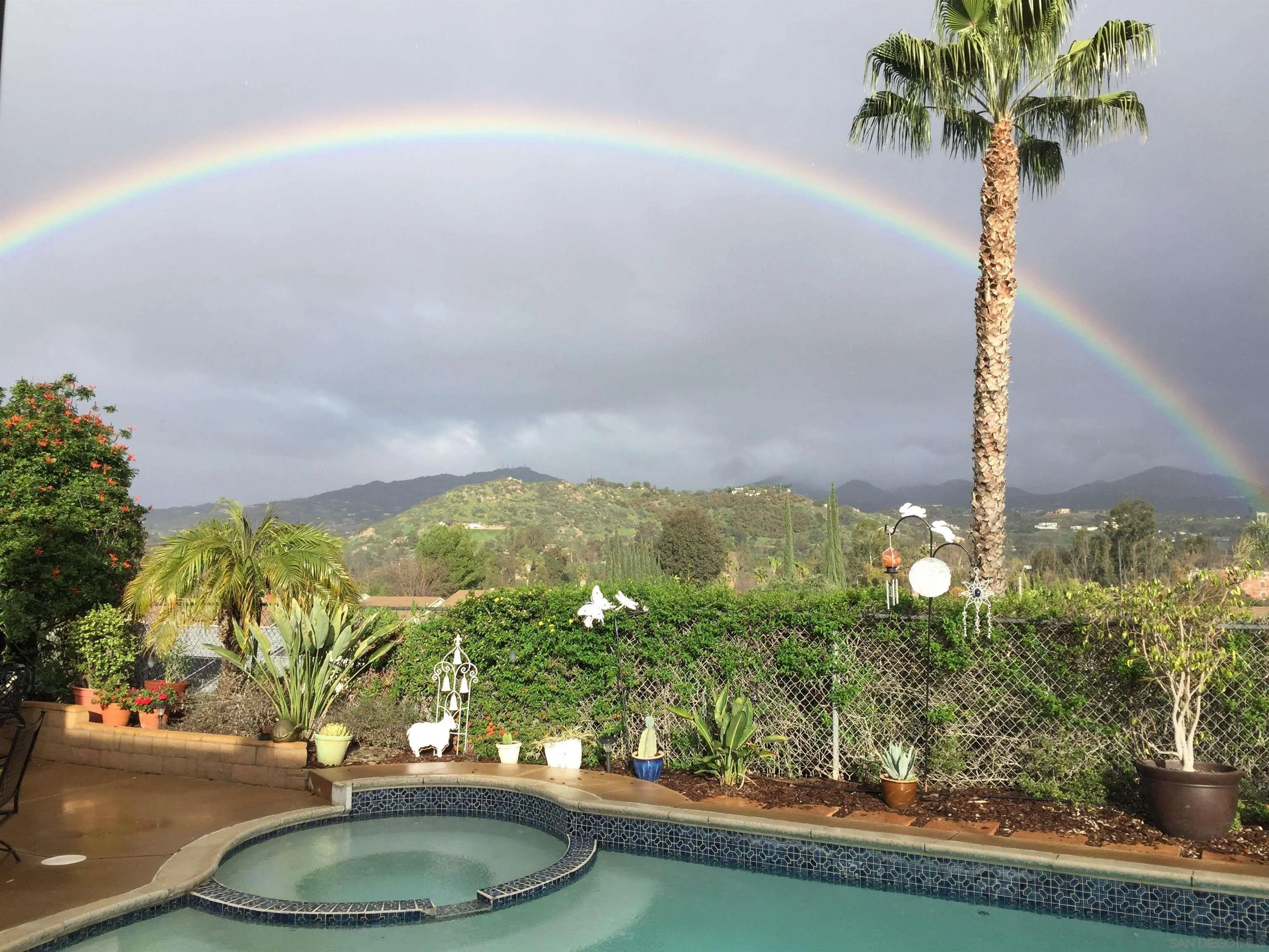 14039 Hermosillo Way Poway, CA 92064 - Photo 30 of 31 a vase of flowers sitting on a table with chairs