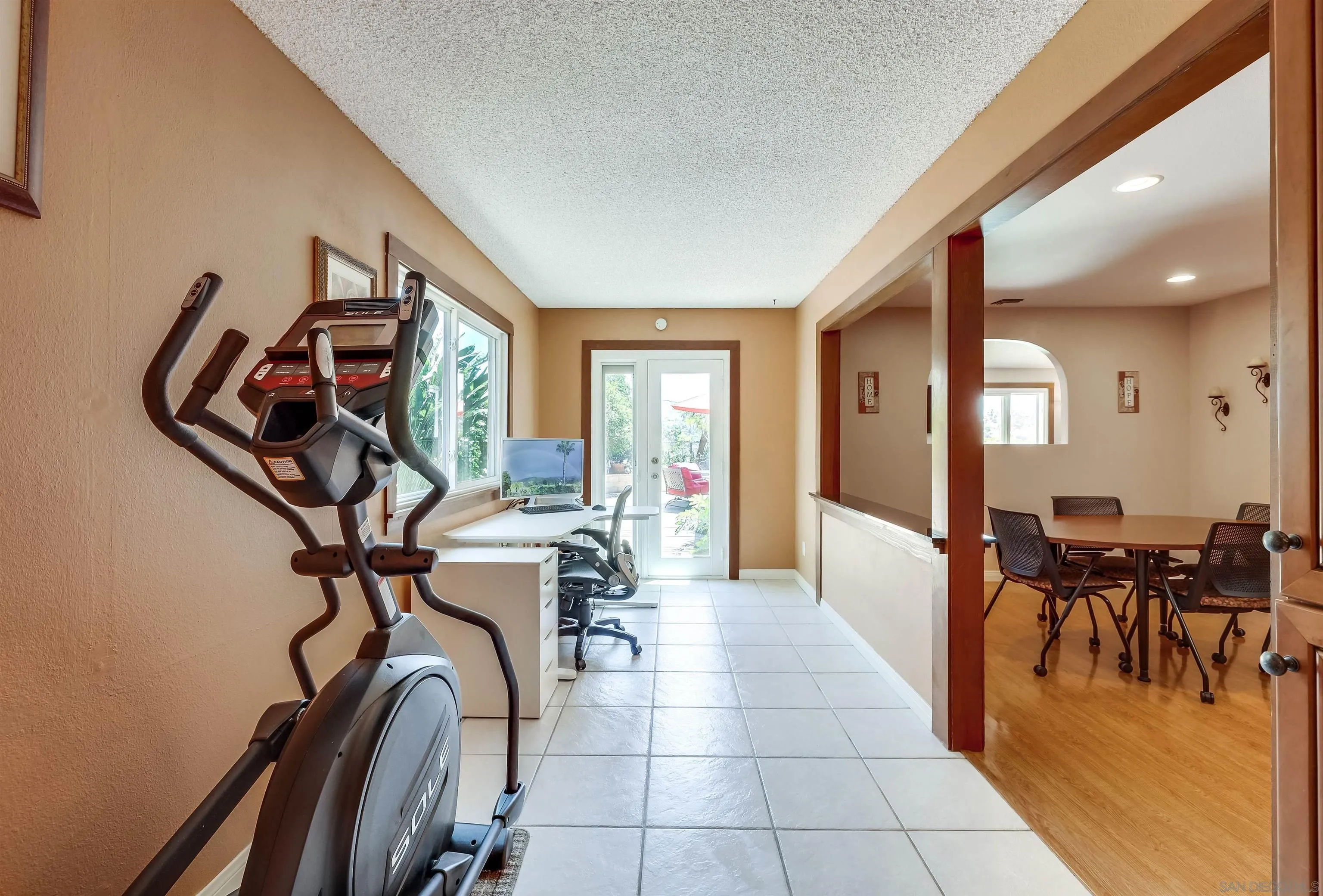 14039 Hermosillo Way Poway, CA 92064 - Photo 9 of 31 a view of a livingroom with furniture and a gym machine