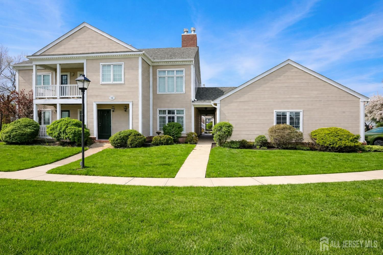 1 H Rutland Lane Monroe Township, NJ 08831 - Photo 1 of 26 a view of a house with a yard and plants