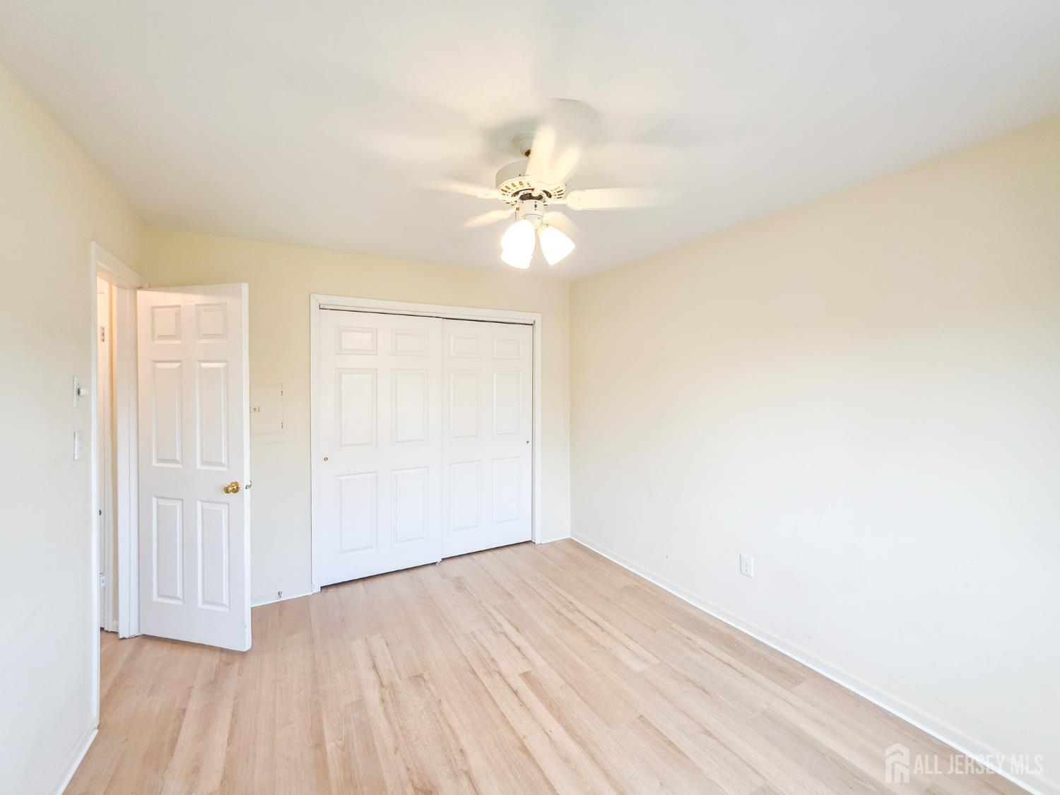 1 H Rutland Lane Monroe Township, NJ 08831 - Photo 13 of 26 an empty room with a window and a ceiling fan