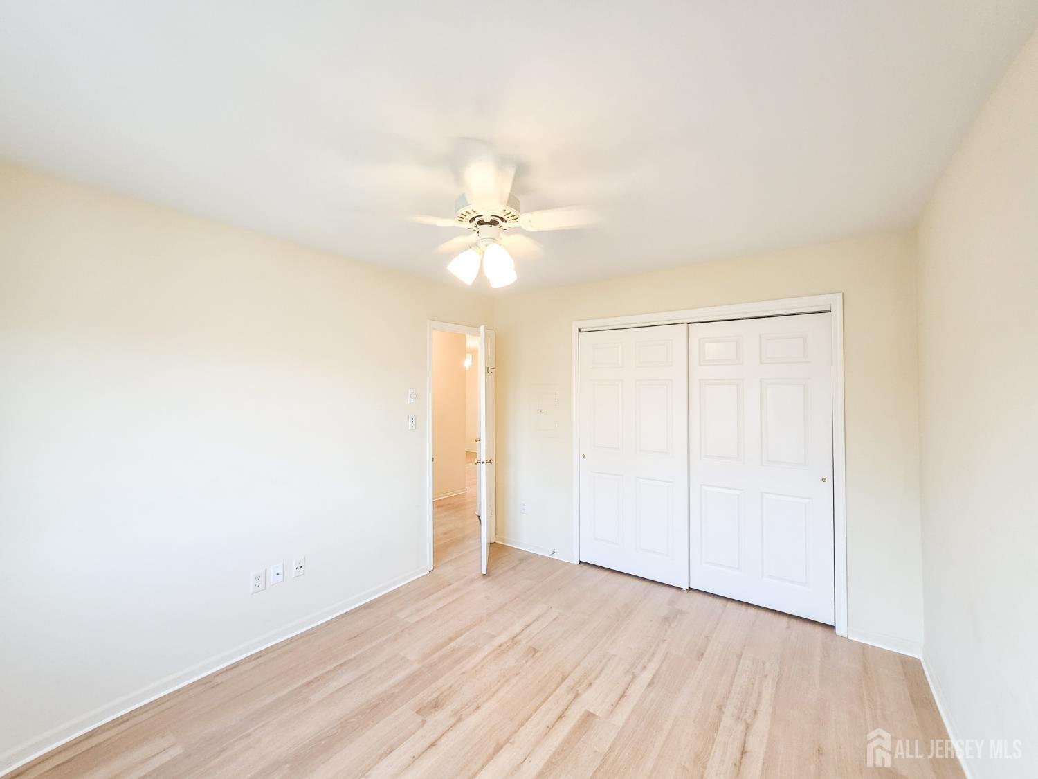 1 H Rutland Lane Monroe Township, NJ 08831 - Photo 14 of 26 an empty room with a window and a ceiling fan
