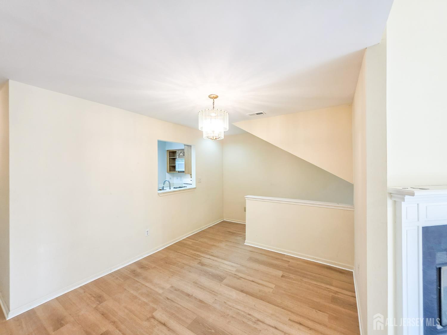 1 H Rutland Lane Monroe Township, NJ 08831 - Photo 16 of 26 a view of empty room with wooden floor