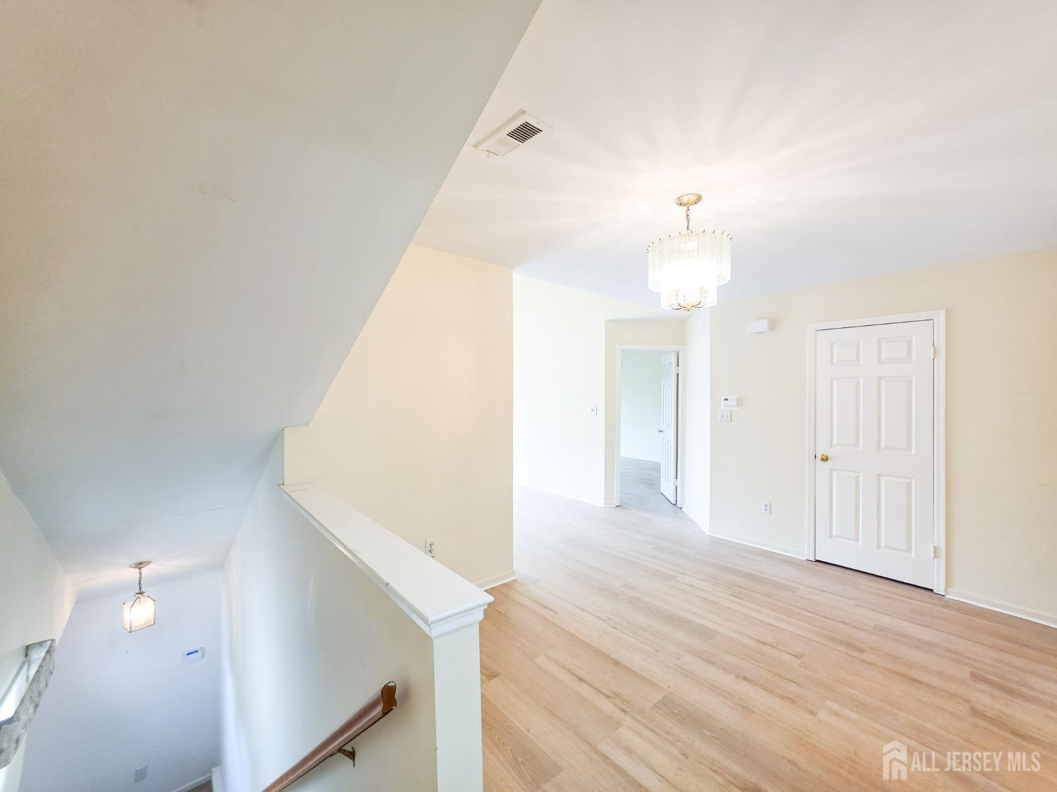 1 H Rutland Lane Monroe Township, NJ 08831 - Photo 18 of 26 a view of a room with wooden floor and staircase