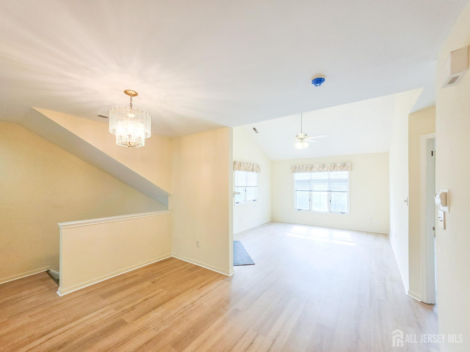 1 H Rutland Lane Monroe Township, NJ 08831 - Photo 19 of 26 a view of an empty room with wooden floor and a window