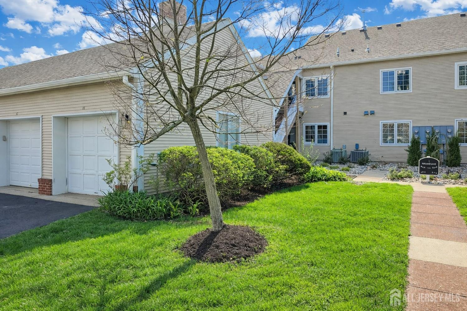 1 H Rutland Lane Monroe Township, NJ 08831 - Photo 2 of 26 a front view of house with yard and green space