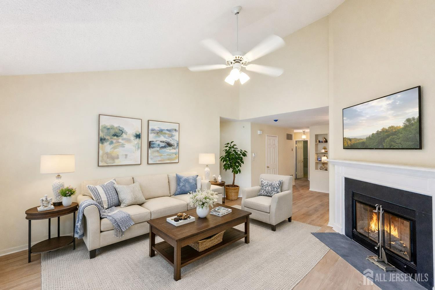 1 H Rutland Lane Monroe Township, NJ 08831 - Photo 21 of 26 a living room with furniture a flat screen tv and a fireplace