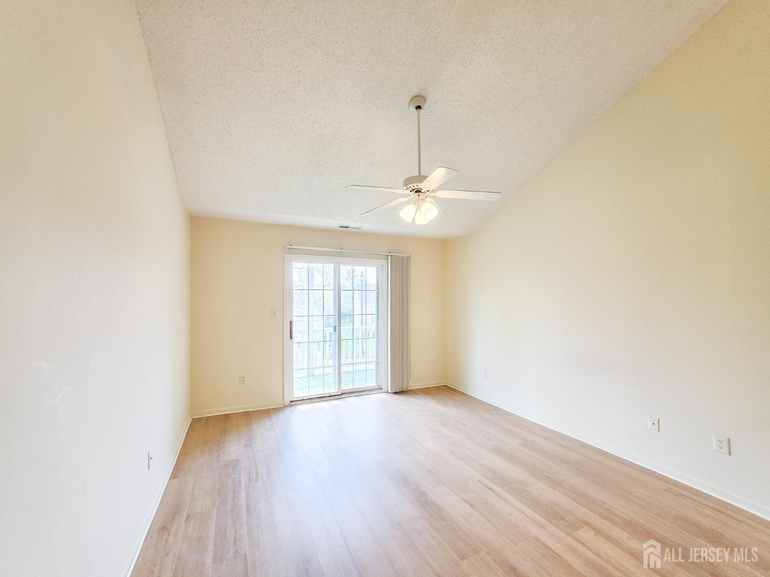 1 H Rutland Lane Monroe Township, NJ 08831 - Photo 22 of 26 an empty room with wooden floor chandelier and windows