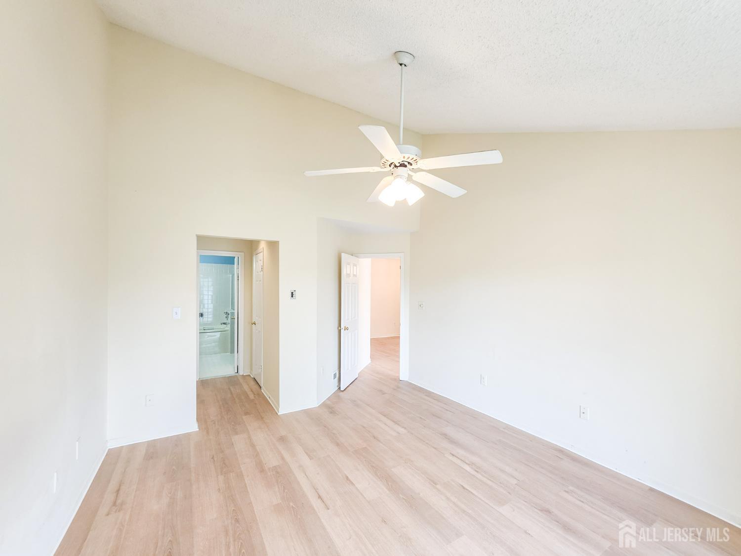 1 H Rutland Lane Monroe Township, NJ 08831 - Photo 24 of 26 a view of a bedroom with a bed and a chandelier
