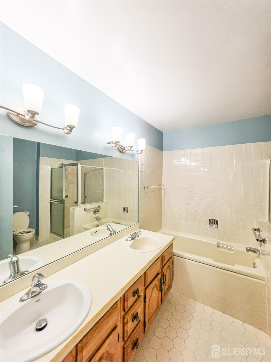 1 H Rutland Lane Monroe Township, NJ 08831 - Photo 25 of 26 a spacious bathroom with a tub sink and mirror