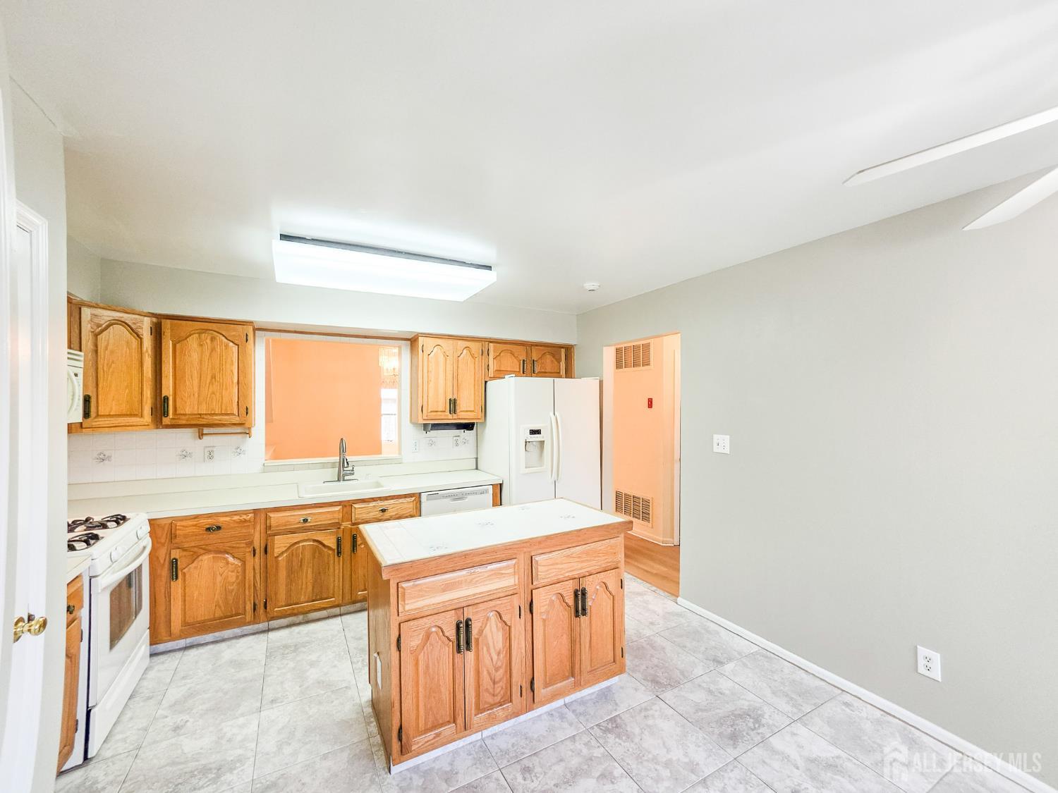 1 H Rutland Lane Monroe Township, NJ 08831 - Photo 5 of 26 a large kitchen with stainless steel appliances granite countertop a sink and a stove