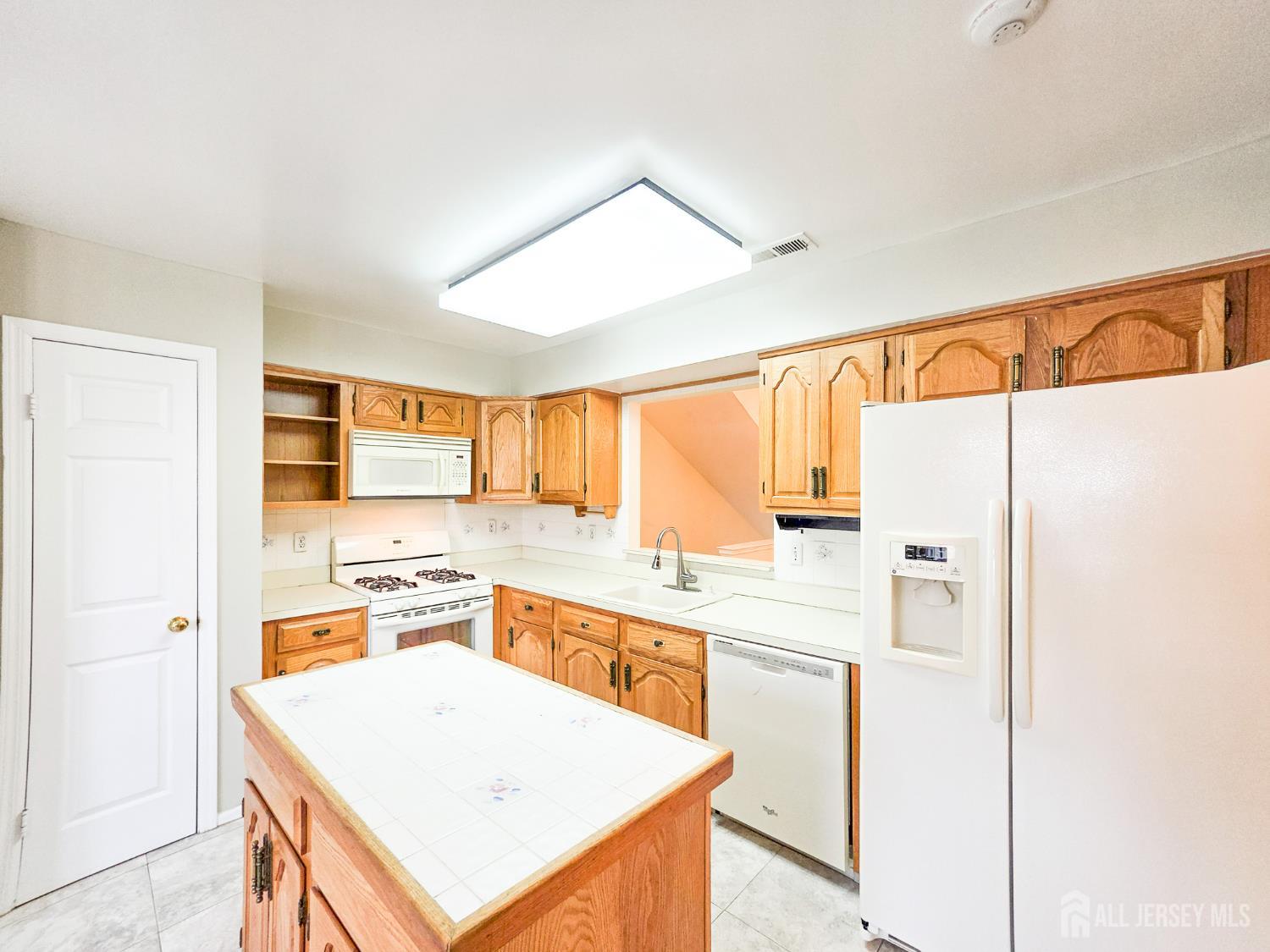 1 H Rutland Lane Monroe Township, NJ 08831 - Photo 7 of 26 a kitchen with stainless steel appliances a refrigerator a sink and white cabinets