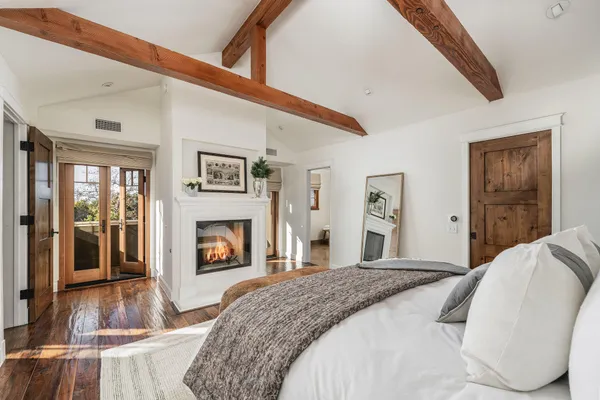 a bedroom with a bed and a fireplace