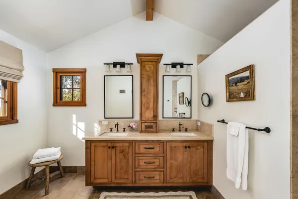 a bathroom with a double vanity sink and a mirror