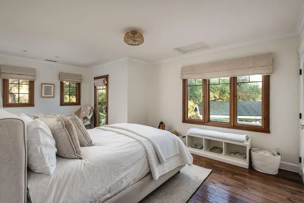 a bedroom with a bed and wooden floor
