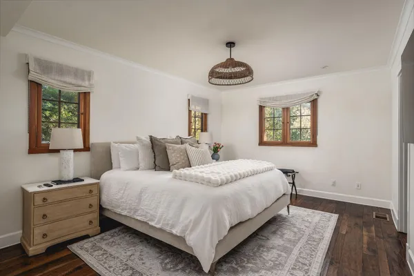 a bedroom with bed and a night stand