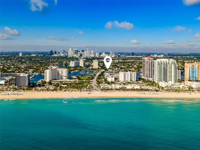 a large kitchen with stainless steel appliances sink a stove and cabinets