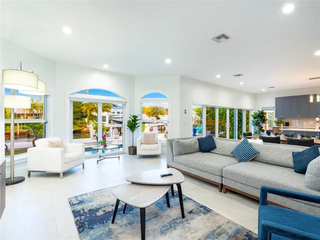 a view of a hallway with wooden floor and a potted plant