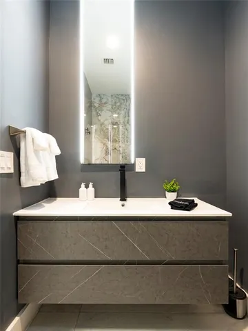 a bedroom with a bed and a ceiling fan