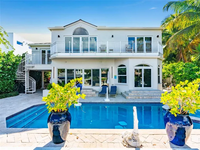 a view of a house with swimming pool and sitting area