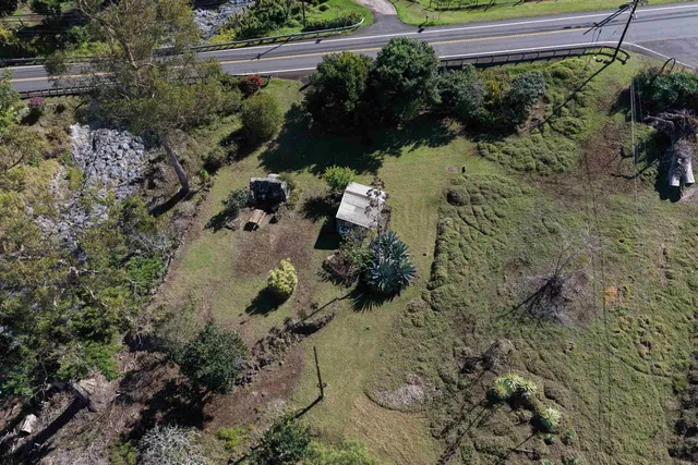 an aerial view of a house with a yard