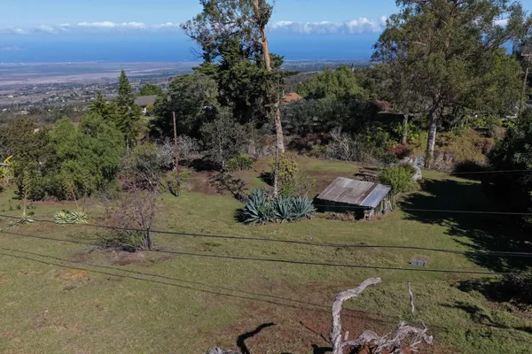 an aerial view of a house with a yard