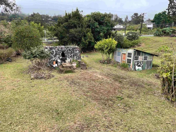 an aerial view of a house with yard and lake view