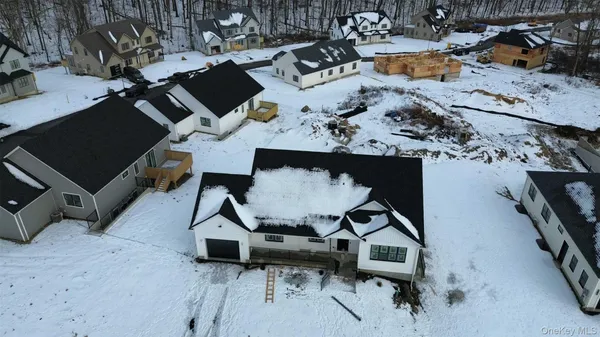 an aerial view of a backyard with table and chairs