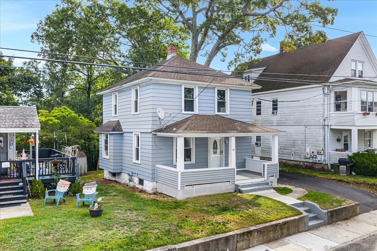 a front view of a house with a yard table and chairs