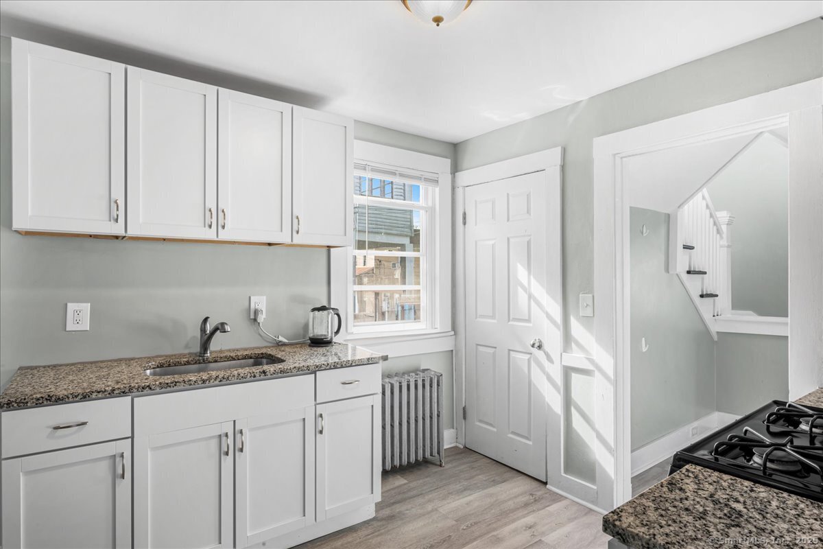55 Raymond Street New London, CT 06320 - Photo 16 of 31 a kitchen with a sink stove and cabinets