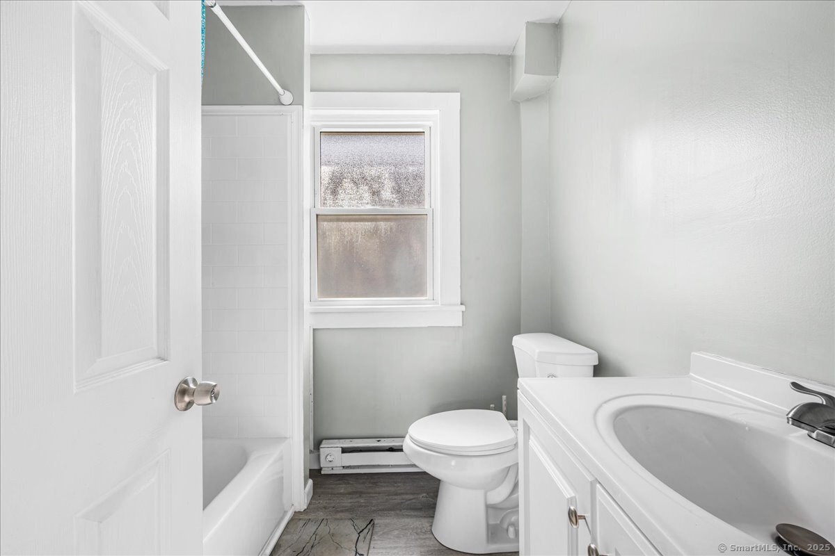 55 Raymond Street New London, CT 06320 - Photo 26 of 31 a white toilet sitting next to a bathroom sink