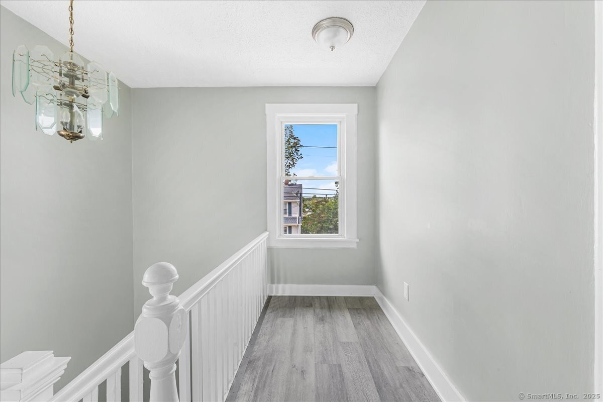55 Raymond Street New London, CT 06320 - Photo 27 of 31 a view of room with window and wooden floor