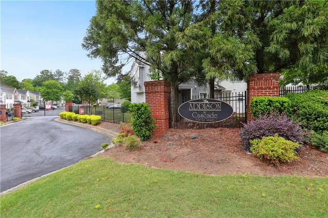 a backyard of a house with a table and chairs