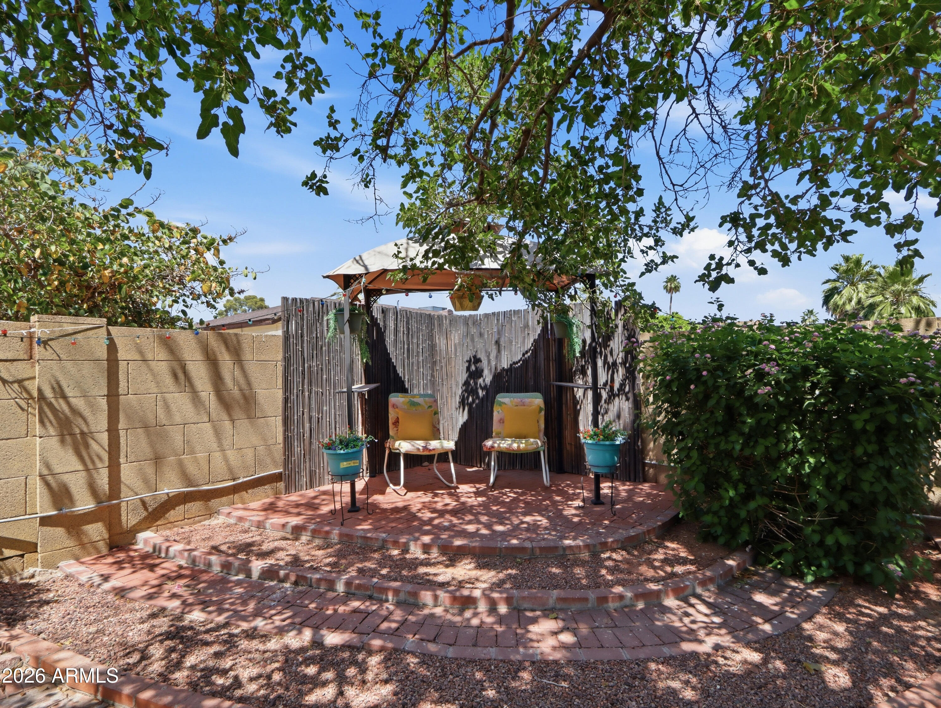 450 Cascada Road Litchfield Park, AZ 85340 - Photo 33 of 40 a backyard of a house with table and chairs