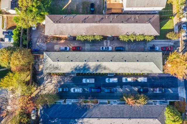 a view of a street with potted plants
